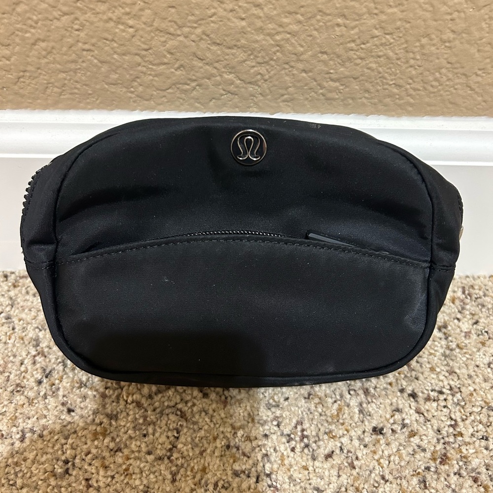 lululemon athletica Black pouch. Front zipper. Interior pockets.